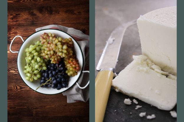 Grapes in a colander next to a block of goat cheese